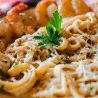 Pasta Aglio E Olio Scampi · Seasoned grilled shrimp with garlic, white wine, and creamy parmesan cheese.