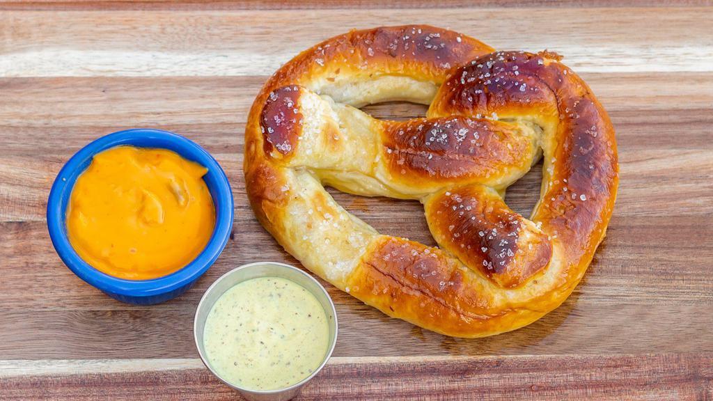 Pretzel · Served with a side of spicy queso sauce and mustard aioli.