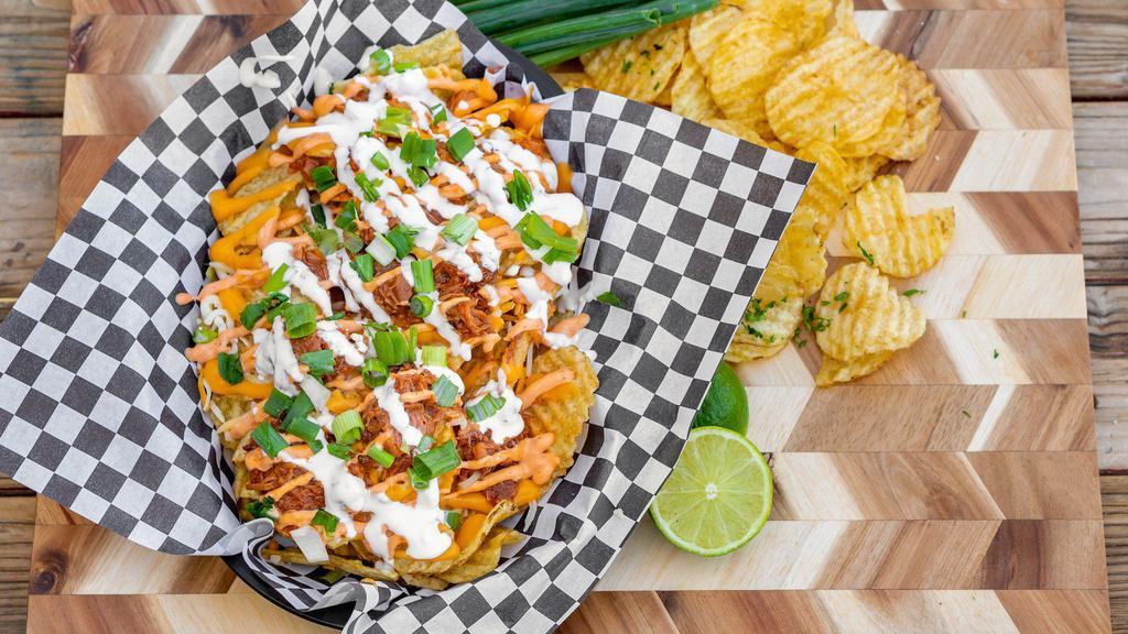 Bbq Pork Nachos · Potato chips topped with cheddar Jack cheese blend, pulled pork, chipotle aioli, Mexican crema, and green onions.