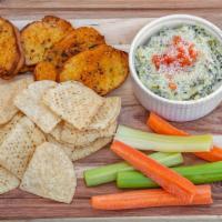 Spinach Artichoke Dip · Topped with diced tomatoes, Parmesan cheese and parsley. Served with tortilla chips and home...