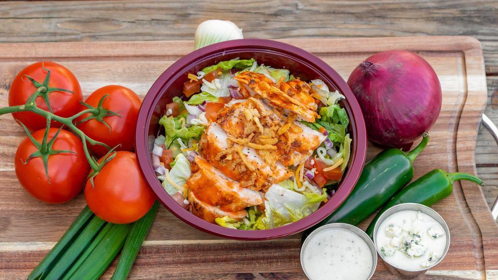 Buffalo Chicken Salad · Romaine lettuce topped with diced tomatoes, cheddar Jack cheese, cucumbers, red onions, and grilled Buffalo chicken. Served with your choice of blue cheese or ranch dressing.