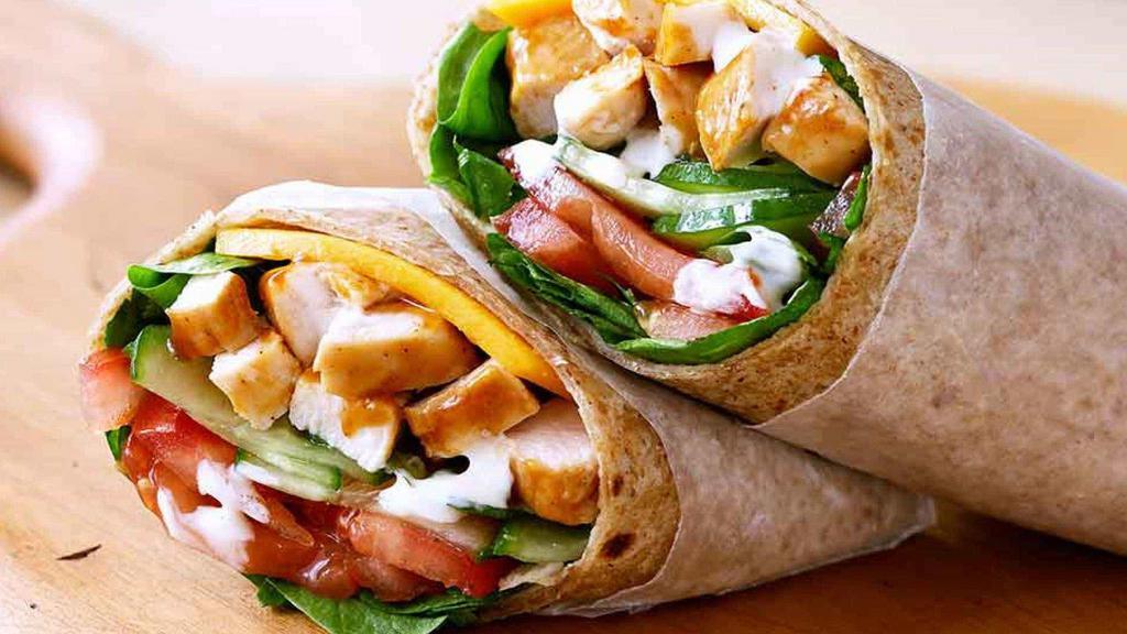 Buffalo Chicken Wrap · Romaine lettuce topped with diced tomatoes, cheddar Jack cheese, cucumbers, red onions, and grilled Buffalo chicken. Served with your choice of blue cheese or ranchdressing.