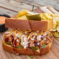 Pulled Pork Sandwich · Pulled pork, signature ancho BBQ sauce, creamy chipotle coleslaw, crispy onions and pickles ...