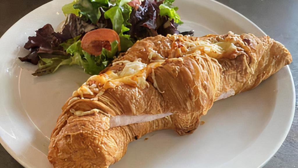 Turkey & Cheese Croissant · Croissant, Emmental cheese, béchamel sauce and sliced turkey breast