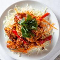 Sweet Chili Chicken · Crispy chicken in garlic chili sauce, fried basil, cabbage, bell pepper.