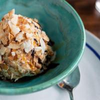 Deep-Fried Ice Cream · Vanilla bean ice cream in a crisp coconut crumb coating topped with chocolate and caramel sa...