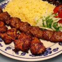 . Combo #3 · One skewer of beef lula kebab and one skewer of chicken kebab with rice, a side salad a roas...