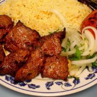 Lamb Kebab · With rice, a side salad a roasted tomato and jalapeno.