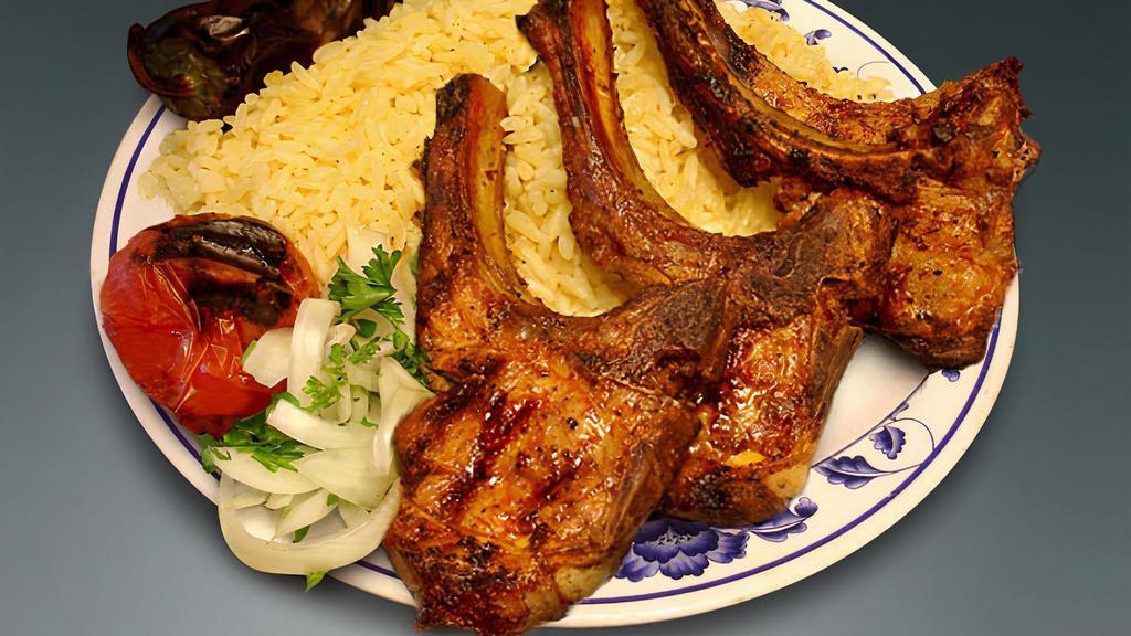 Lamb Chops · With rice, a side salad a roasted tomato and Jalapeno.