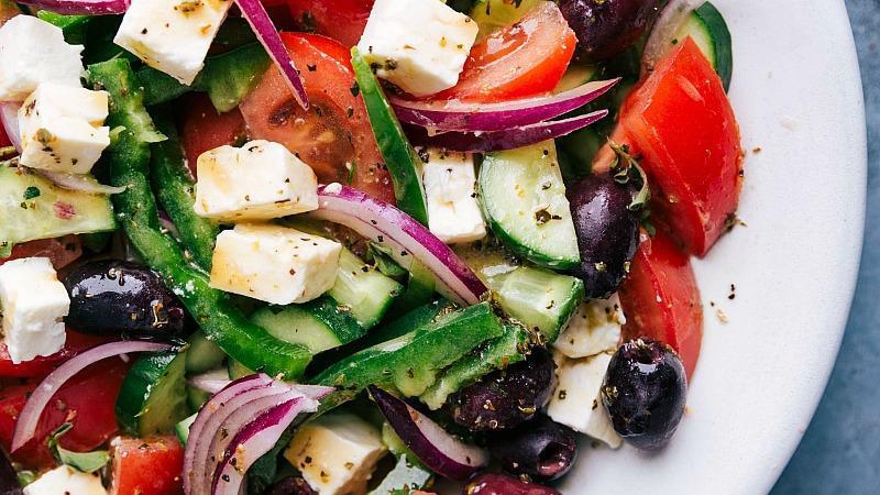 Greek Salad · Tomatoes, cucumbers, onions, feta cheese and olives and dressed with salt, pepper, Greek oregano, and olive oil.