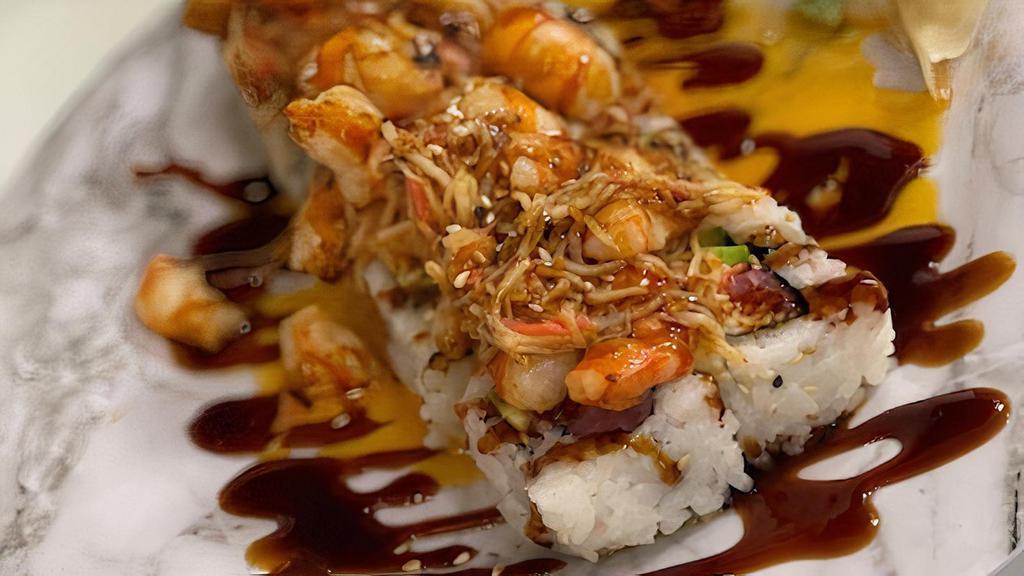 Surfer Roll · Spicy tuna, cucumber, avocado, topped with baked shrimp & imitation crab, yum yum sauce
and eel sauce.