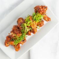 Korean Wings · Battered and fried, tossed in a sweet, spicy glaze with garlic and ginger.