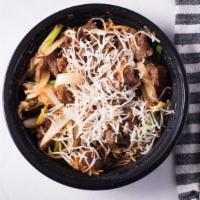 Mongolian Beef · Sliced beef stir fried with onions and served over a bed of vermicelli noodles.
