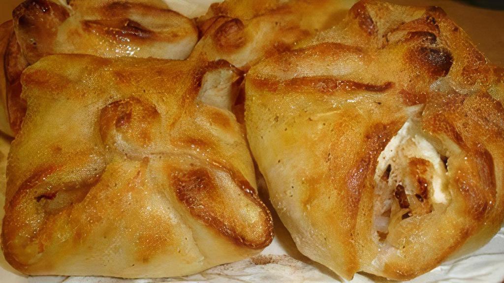 Apple Sourdunks · Four hand made sourdough pastries filled with cinnamon apples, cream cheese, almonds, and coconut. Drizzled with warm butter and cinnamon sugar.