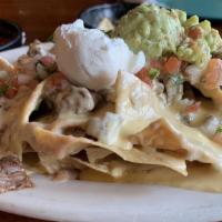 Supremos Nachos · Carne asada, chicken, shredded beef, or ground beef cheese covered. Served with sour cream, ...