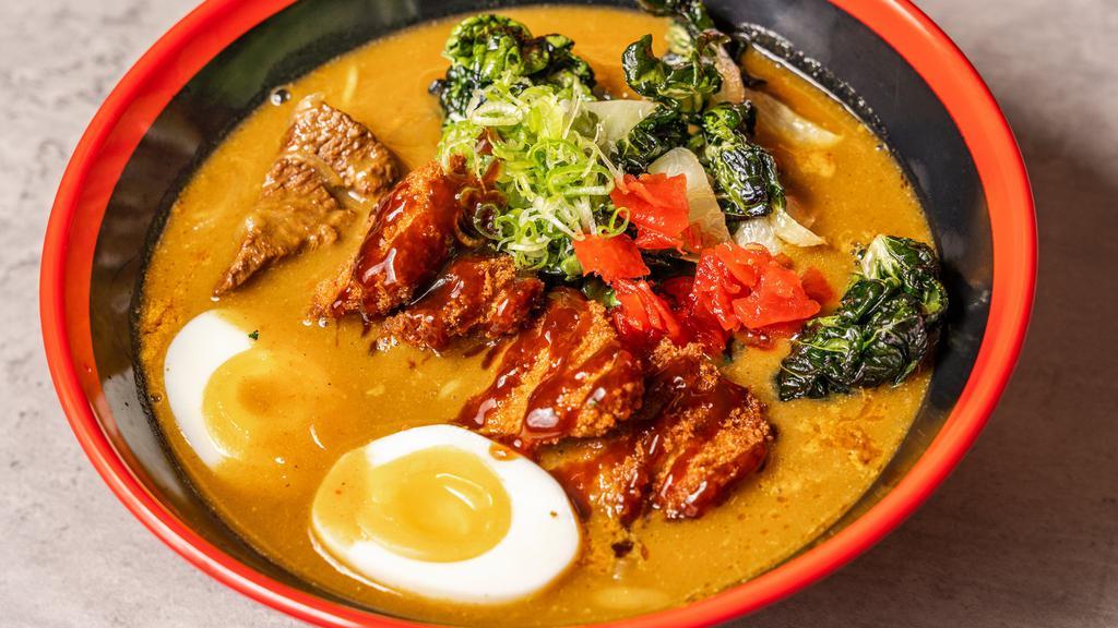 Curry Ramen · Japanese beef curry flavored tonkotsu broth, Japanese style pork cutlet, onsen tamago (soft boiled egg), bok choy, negi (spring onion) and wheat noodles.