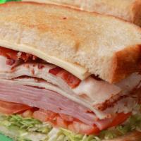 Deli Club  · Turkey, ham, bacon, white American cheese, lettuce, tomato, onion, and mayo on sourdough bre...