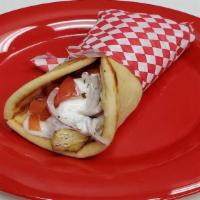 Marinated Chicken Souvlaki Sandwich · Chicken souvlaki, tomatoes, onion and tzatziki sauce wrapped in pita.