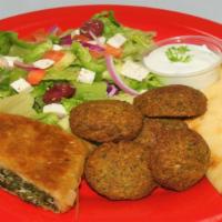Falafel Plate · Falafel, spinach pie, Greek salad, pita bread tzatziki sauce, and hummus.