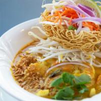 Khao Soi Noodle Soup · Spicy. Thin rice noodles, bean sprouts, yellow curry, crispy noodles, crispy shallots, and c...