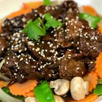 Heavenly Beef · Stir-fried beef with sesame house sauce on bed of cabbage, mushrooms, carrot, bell peppers, ...