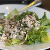Larb Gai · Ground chicken tossed with lime juice, Thai spices, onions, a touch of chili, roasted rice p...