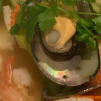 Tom Yum · Traditional Thai hot and sour soup with lemongrass and kaffir lime leaves infused broth, mus...