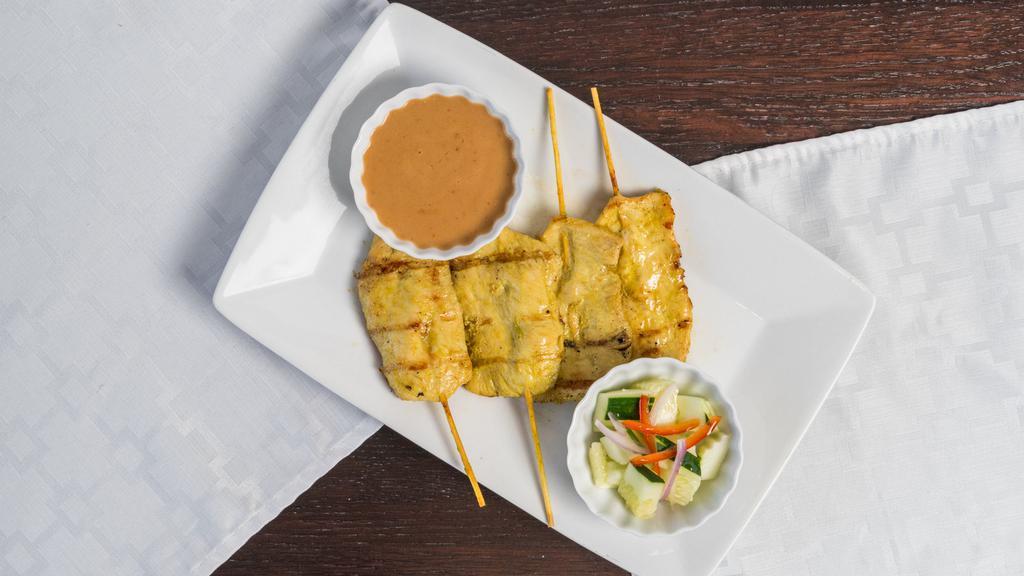 Chicken Satay · (Gluten-Free) Chicken skewer marinated in coconut milk with herbs and spices, grilled then glazed with peanut sauce, accompanied with mini cucumber salad