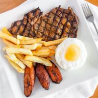 Bistek A Lo Pobre · USDA Choice Ribeye steak with seasoned rice, topped with fried egg and served with fried pla...