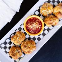 Garlic Knots · House made and hot from the oven. Topped with grated parmesan and served with marinara dippi...