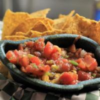 Chips & Salsa · Tortilla Strips and house made spicy salsa.