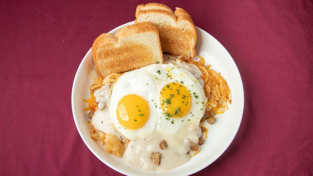 The Country · Two eggs, sausage, country gravy, Cheddar cheese, and crispy onion. Stacked with hash browns and served with toast or grits.