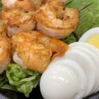 Grilled Shrimp Louie Salad · Grilled shrimp, boiled eggs, avocado, tomato, cucumber, and fried onions. Served with garlic...