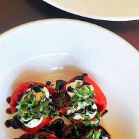 Caprese Salad · Sliced tomatoes, fresh mozzarella, fresh basil and balsamic vinegar.