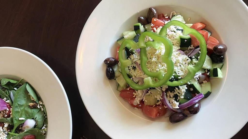 Village Salad · Tomatoes, cucumbers, onions, bell peppers, Kalamata olives and feta tossed in Italian dressing.