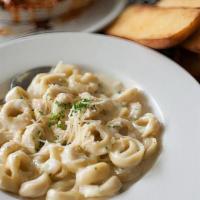 Tortellini Ala Creme · Cheese filled pasta in garlic cream sauce, parsley and Parmesan cheese.
