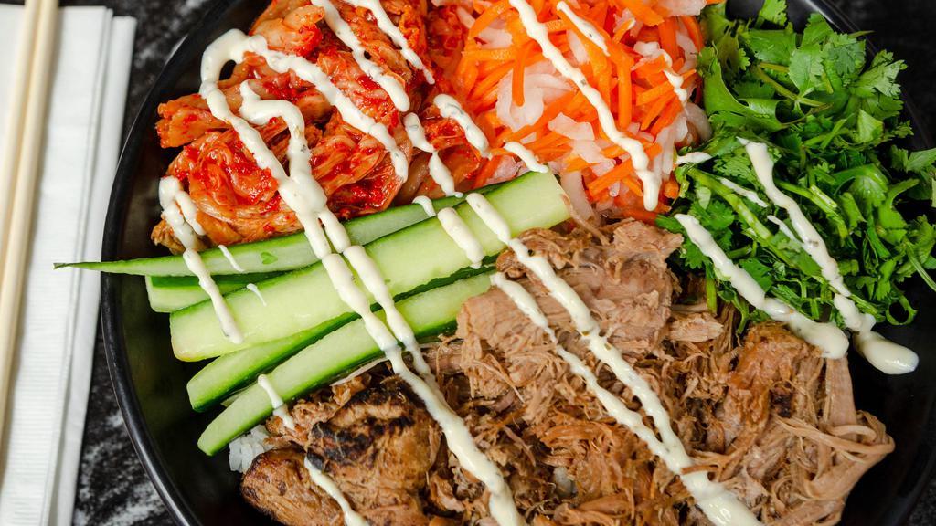 Banh Mi Bowl · Five spice pork, pickled daikon and carrots, kimchi, cucumber, cilantro, jalapeño dressing.