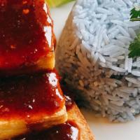 Tofu Bomb · Golden brown tofu tossed in spicy tangy sweet sauce, topped on rice.