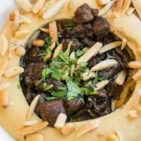 Hummus Awarma
 · Gluten-free. Hummus topped with minced ground lamb and pine nuts. Contains sesame.