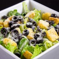 Caesar Salad · Romaine lettuce, croutons, black olives, parm, cheese.