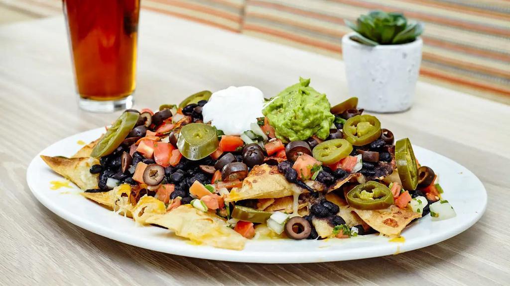 Nachos · House made chips, cheddar and jack cheeses, pico de gallo, guacamole, sour cream, olives, jalapeños.