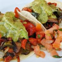 Veggie Tacos · Portobello mushroom, poblano and red peppers, sweet onion.