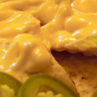 Cheesy Nachos · Classic styled nachos with cheese and jalapeños.