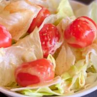 House Salad · Iceberg lettuce and cherry tomatoes topped with homemade sesame dressing.
