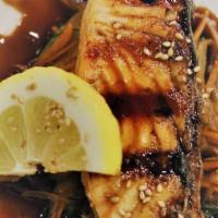 Salmon Teriyaki · Grilled salmon thigh glazed with teriyaki sauce bed on sautéed vegetables.