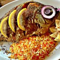 Tilapia Fish · Fresh whole deep fried fish stuffed with spices and a lemon slice. Served with rice and pita...