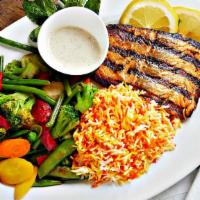 Salmon Seafood · Six oz piece of fresh grilled Alaskan salmon topped with Cajun spices and served with garlic...