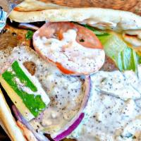 Gyro Sandwich · A traditional well known dish roasted slowly and served in a pita bread wrap filled with fre...