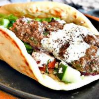 Kafta Kebab Sandwich · Ground lamb and beef mixed with fresh onions, parsley and spices wrapped in a warm pita bread.