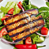 Salmon Salad · Grilled  Salmon on top of fresh lettuce, tomato, onions, olives  served  with sauce and pita...